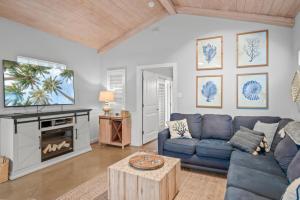 a living room with a blue couch and a tv at Island Time in Port Aransas