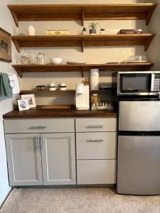 a kitchen with a refrigerator and a microwave at Spacious Suite Wkitchenette in Ligonier