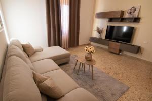 a living room with a couch and a tv at Casa Martina Tuscany in Certaldo