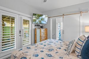 a bedroom with a bed and two windows at Island Time in Port Aransas +33 photos