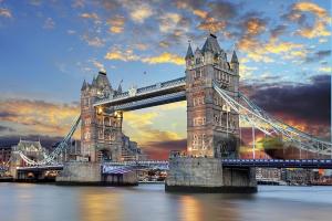 a suspension bridge over the water with a cloudy sky at Modern Serviced 3-bedroom flat in East London in London