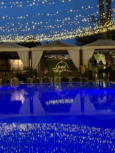 a group of people standing under a tent with lights at Hotel Redebora in Torregrotta