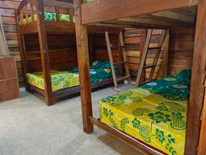 a room with two bunk beds in a house at Fantastic B"n"B in Gili Air