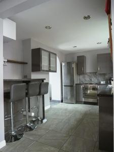 a kitchen with stainless steel appliances and a counter at Urban Oasis in Abbey Wood