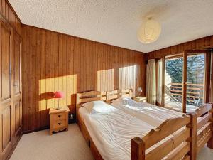 a bedroom with a large bed and a window at Richemont 213 in Verbier