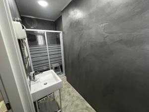 a bathroom with a sink and a mirror at La Piazza BeB in Tropea