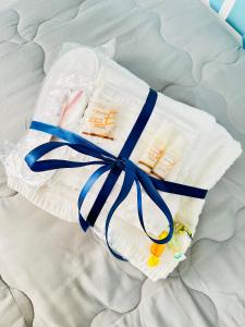 a package of diapers with a blue ribbon on a bed at Casa Lilla in Monreale