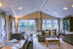 a living room with a couch and a table at Newlands Holidays in Bridport