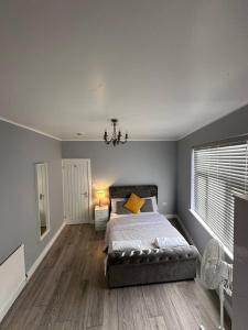a bedroom with a bed and a large window at Herbies Stay in Southend-on-Sea