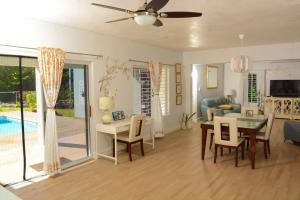 a living room with a table and a dining room at Retreat 2 Jamaica in Runaway Bay