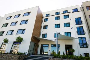 a white building with blue windows at Residence Trafick in Prague