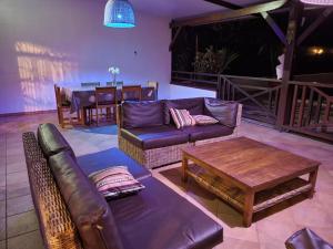 a living room with a couch and a table at Hudace maison partagée in Saint-Laurent du Maroni