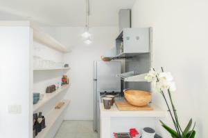 a kitchen with white walls and a refrigerator at Maison Barchetta in Via Giulia - Piazza Navona in Rome