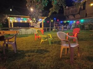 a group of chairs sitting in the grass at night at Aux 2 Rivières in Saint-Léger-de-Peyre