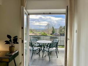 a patio with a table and chairs on a balcony at HoliDeis - Art-Apartment - 3min to Monschau - big Terrace in Monschau