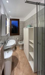 a bathroom with a sink and a toilet and a shower at Villa Aurelia - Pool, BBQ & Tennis Court - San Teodoro in San Teodoro +22 photos