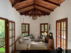 una sala de estar con un sofá y una mesa en Chalé Carolina Bela, en Guaramiranga 20 fotos más