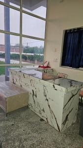 a room with a large marble bed in front of a window at Hotel Shri kishori farm in Mathura