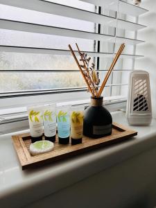 a group of five candles on a tray on a window sill at *Newcastle City* Modern Flat With FREE Parking in Newcastle upon Tyne