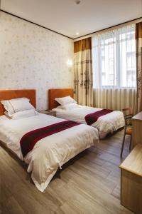 Postel nebo postele na pokoji v ubytování Igiban Hotel