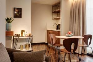 a living room with a table and chairs at Brama in Bromley