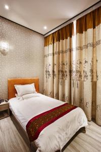 Postel nebo postele na pokoji v ubytování Igiban Hotel
