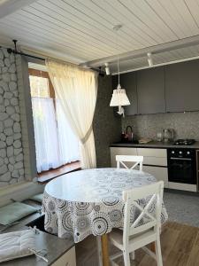 a kitchen with a table and a dining room at Apartments Mandry in Yaremche