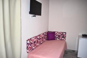 a room with a couch with a tv on the wall at Venice Apartments 2 in Limenaria