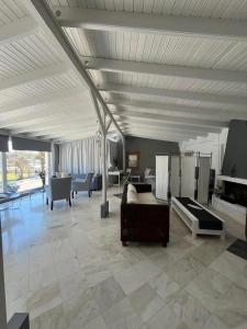 a living room with a couch and a table at Luxury Loft in Porto Heli !!! in Porto Heli