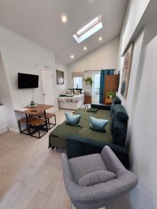 a living room with a couch and a tv in it at Contemporary studio with private patio, free on-street parking and underfloor heating in Bournemouth