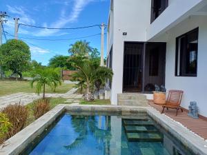 a swimming pool in front of a house at Calodyne residence in Grande Gaube