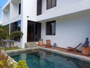 a villa with a swimming pool and a house at Calodyne residence in Grande Gaube +10 photos