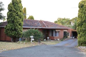 a red brick house with trees in front of it at Comfort and Convenient in Perth