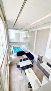 a living room with a pool in the background at شاليه المنى - الخبر - للعائلات in Al Khobar