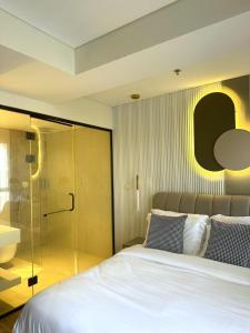 um quarto com uma cama e uma cabina de duche em vidro em Allenbeach TLV- apart Hotel- Adults only em Tel Aviv