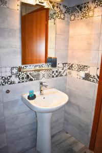 a bathroom with a white sink and a mirror at Venice Apartments 2 in Limenaria +23 photos