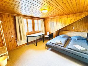 a bedroom with a bed in a wooden room at Cozy Apartment in Vintage House in Kandersteg in Kandersteg