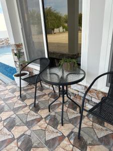 a patio with a table and chairs on a porch at Rashed Farm in Al Rahba