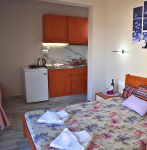 a bedroom with a bed with towels on it at Venice Apartments 2 in Limenaria