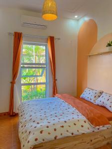 a bedroom with a bed with a large window at Nhà Của Bối - Villa Mộc Châu in Mộc Châu