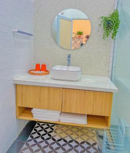 a bathroom with a sink and a mirror at Nhà Của Bối - Villa Mộc Châu in Mộc Châu