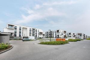 a parking lot in front of a apartment complex at Golden Apartment Prestige with Parking in Warsaw Bemowo in Warszawa