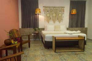 1 dormitorio con 1 cama, mesa y sillas en Hotel Boutique Casa Xaan, en Valladolid