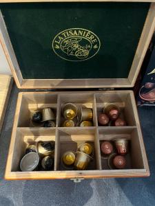 a wooden box filled with different types of chocolates at Appart'hôtel PrestigeHost in Orléans