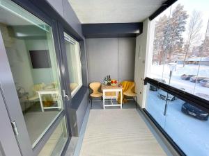 a small room with a table and a window at Docent's Flat in Joensuu