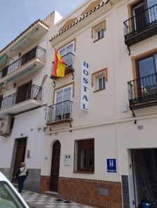 una mujer pasa por delante de un hotel en Hostal Ana - Adults Recommended en Nerja