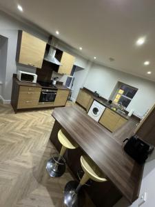 a kitchen with a wooden counter top in a room at Town Centre 2 bedroom apartment in Wick