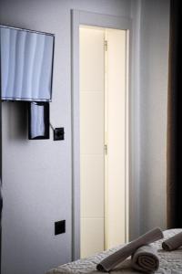 a door to a room with a bed and a mirror at Horizont Apart-Hotel in Shkodër