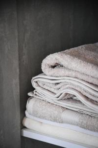 a stack of towels sitting on a shelf at Horizont Apart-Hotel in Shkodër