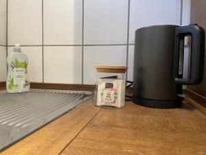 a coffee maker and a bottle of milk next to a refrigerator at Apartment in Natur und Flughafen Nähe in Nuremberg